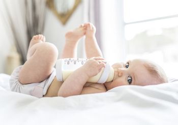 Dziewczynka pije mleko z butelki